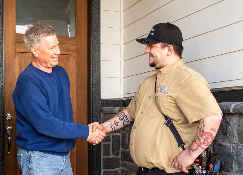 HVAC technician greeting the homeowner