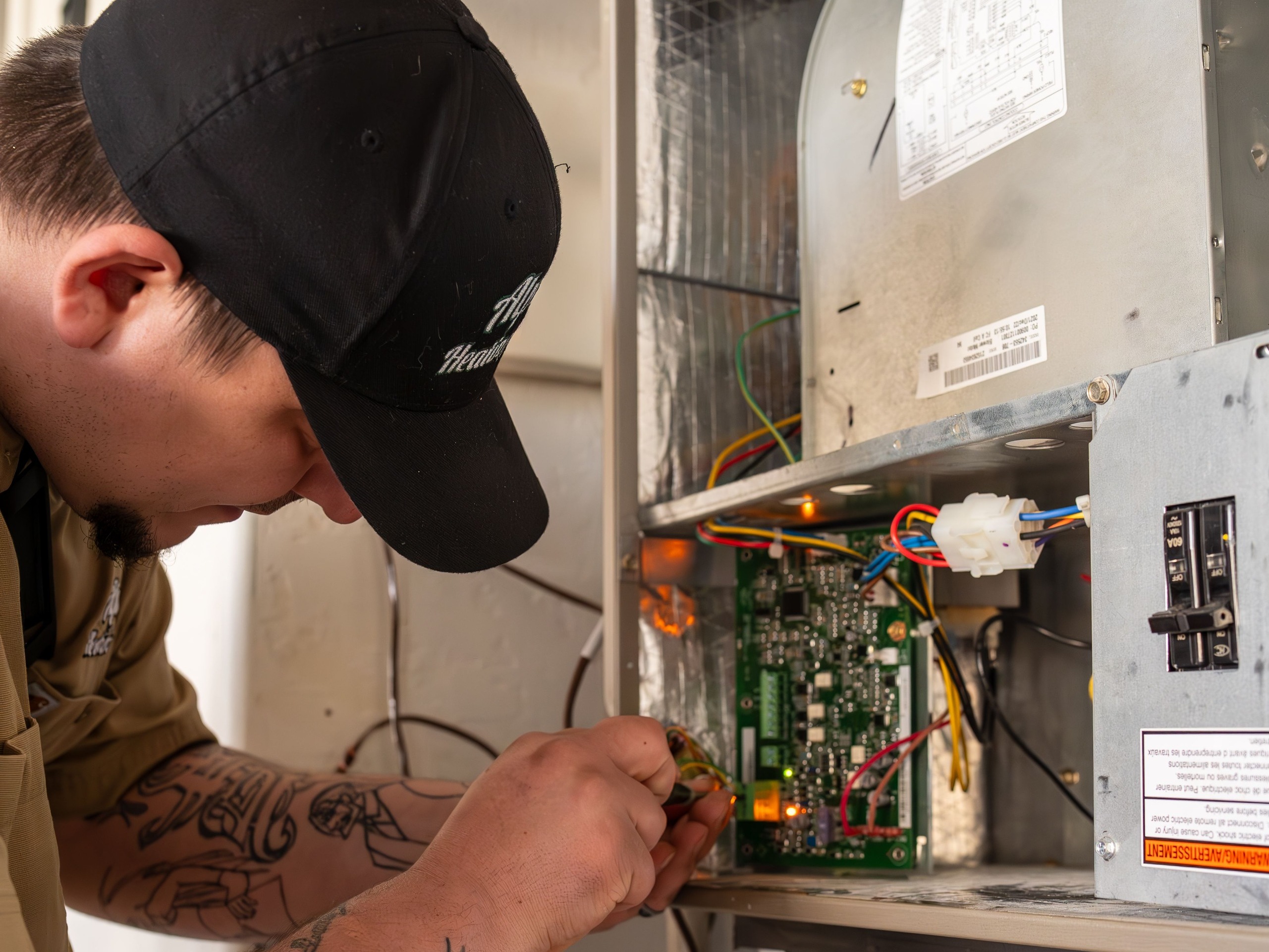 Technician repairing a heat pump in Bandon home.