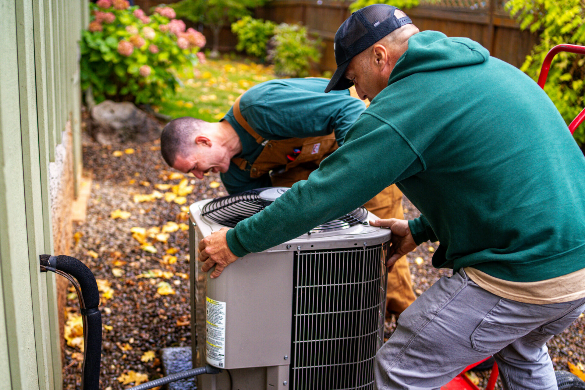 Technicians replacing a heat pump in Bandon
