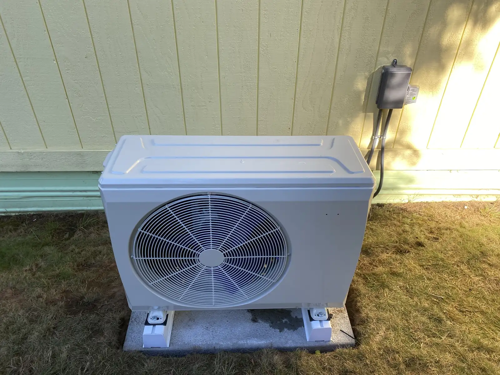 Coastal Oregon ductless mini-split outdoor unit installed beside a home for year-round heating and cooling comfort.