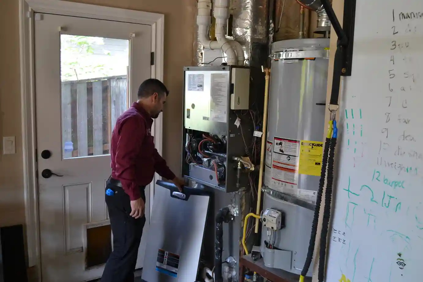 Technician inspecting a furnace in a Bandon home to diagnose heating issues and assess repair costs.