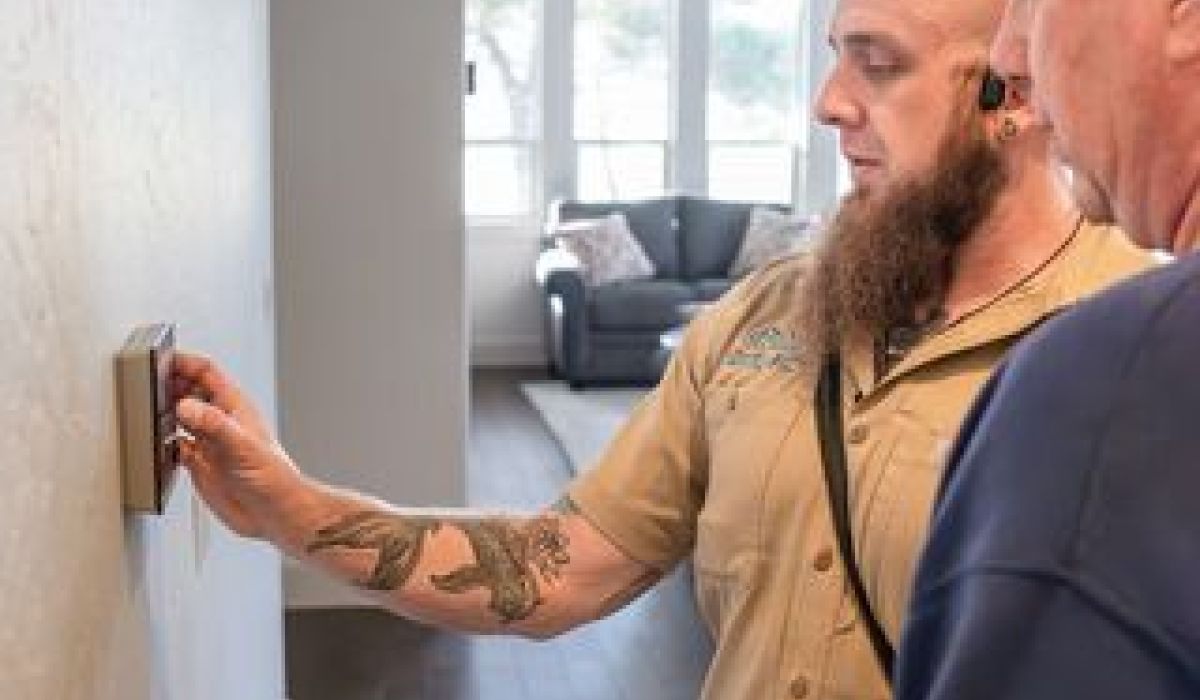 Image of an Alpha Bandon technician repairing a furnace